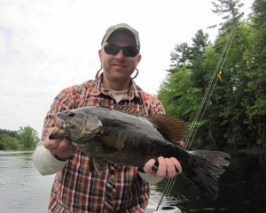Abe Downs of Blackwater Fly Fishing with a 20 1/2″ Smallmouth Bass on the Wisconsin River.